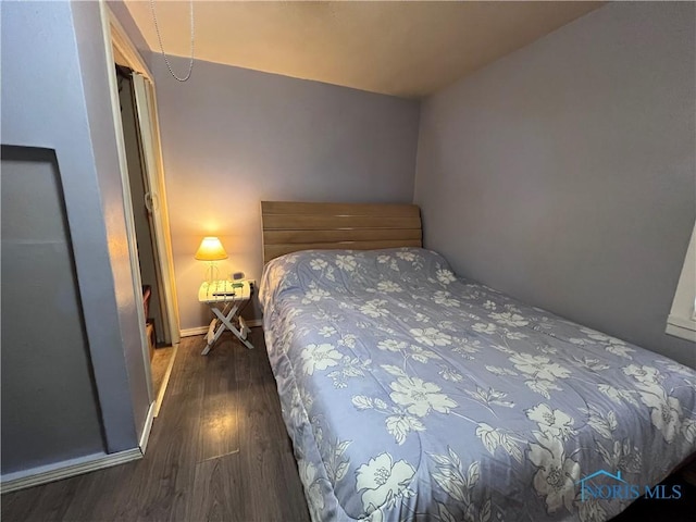 bedroom featuring dark wood-type flooring