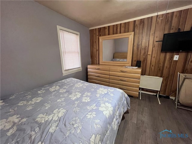 bedroom featuring hardwood / wood-style flooring and wood walls