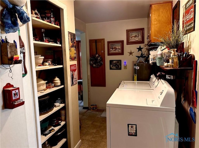 clothes washing area featuring independent washer and dryer and water heater