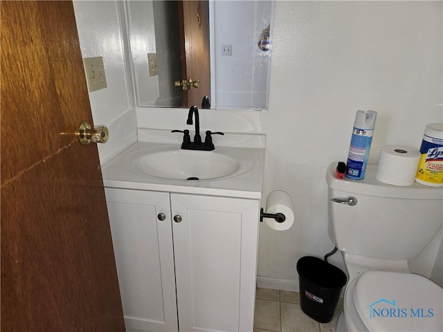 bathroom featuring tile patterned flooring, vanity, and toilet