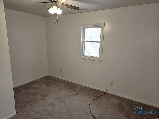 carpeted spare room with ceiling fan