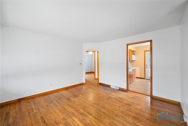 unfurnished room with light hardwood / wood-style floors