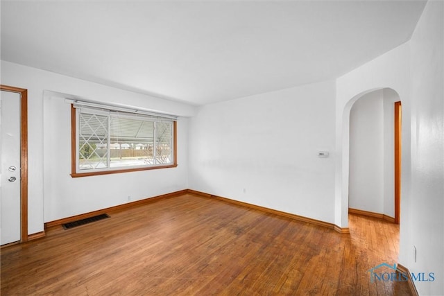 spare room with wood-type flooring