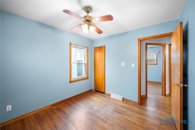 unfurnished bedroom featuring light hardwood / wood-style floors and ceiling fan