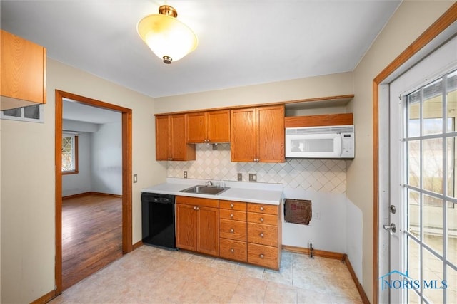 kitchen with dishwasher, sink, and tasteful backsplash