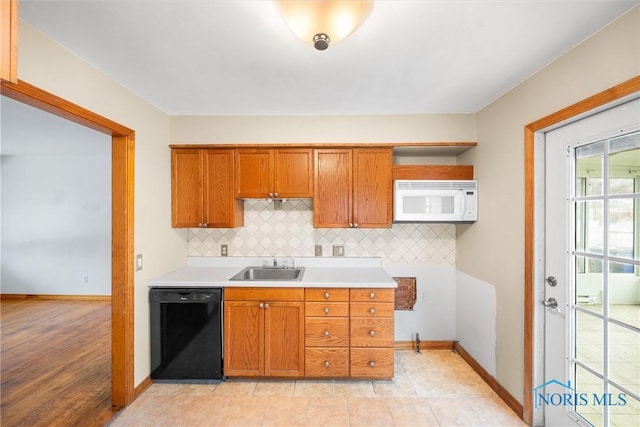 kitchen featuring dishwasher, backsplash, and sink