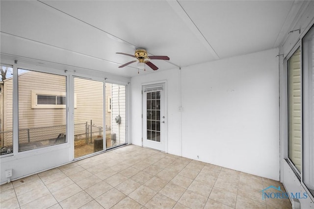 unfurnished sunroom with ceiling fan