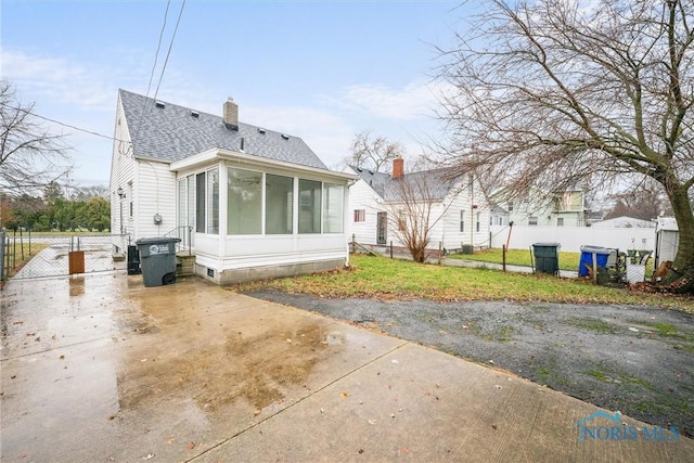 back of house featuring a sunroom