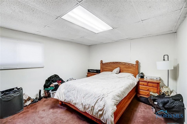 carpeted bedroom featuring a paneled ceiling