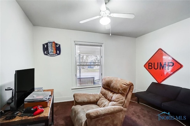 interior space with dark colored carpet and ceiling fan