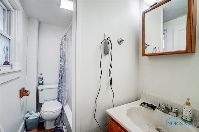 bathroom featuring curtained shower, vanity, and toilet