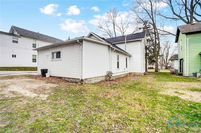 back of house with a yard and cooling unit