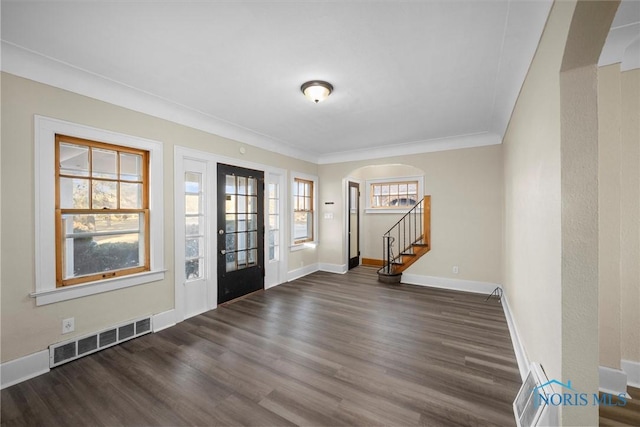 interior space with dark hardwood / wood-style floors and ornamental molding