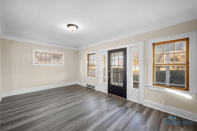 entryway featuring dark wood-type flooring and ornamental molding