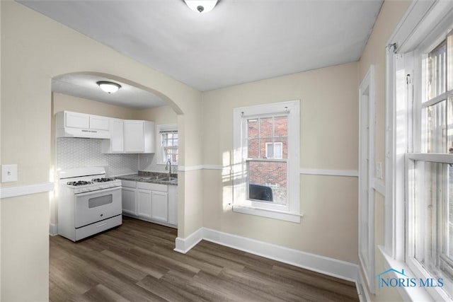 kitchen featuring white cabinetry, sink, white range with gas stovetop, extractor fan, and decorative backsplash