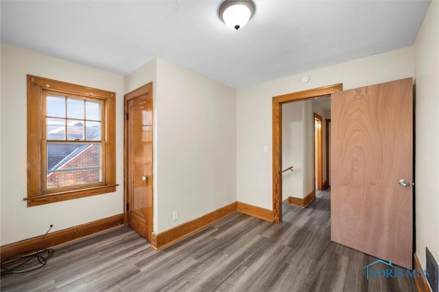 unfurnished room featuring dark wood-type flooring