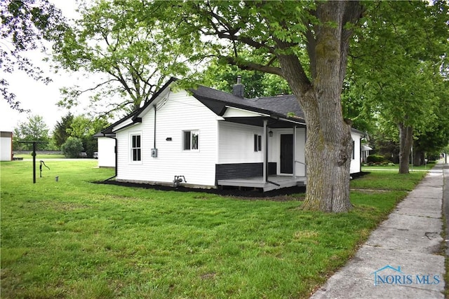 view of home's exterior with a yard