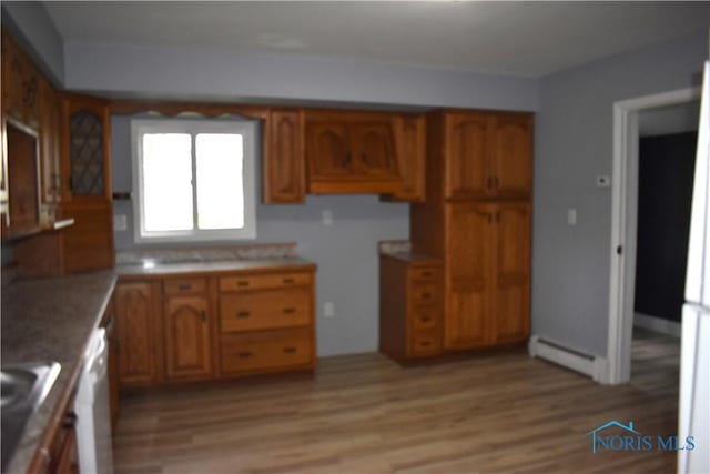 kitchen with white dishwasher, light hardwood / wood-style floors, sink, and baseboard heating