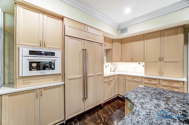 kitchen featuring light brown cabinets, paneled fridge, crown molding, oven, and dark stone counters