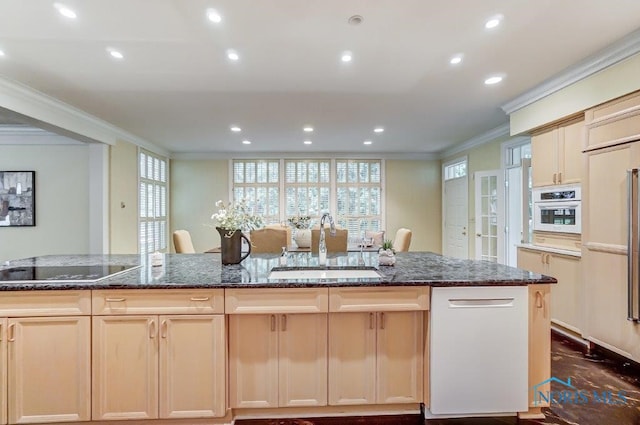 kitchen with a center island with sink, black electric stovetop, sink, dark stone countertops, and ornamental molding