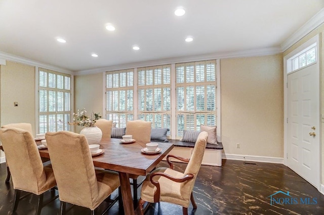 dining space with crown molding