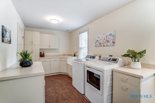 washroom featuring washer and clothes dryer, cabinets, and sink