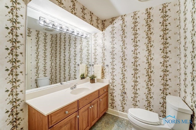 bathroom featuring vanity and toilet