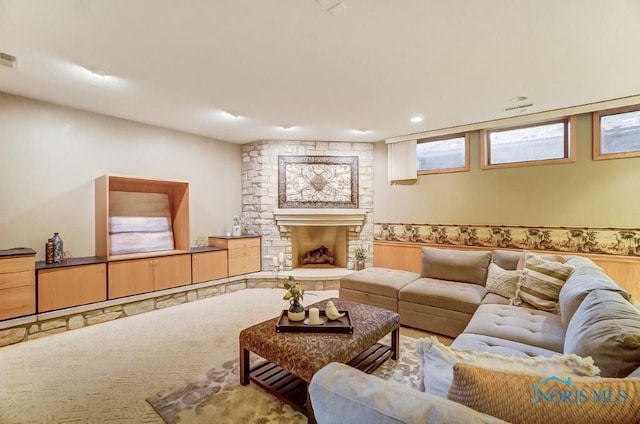 living room with a fireplace and carpet floors