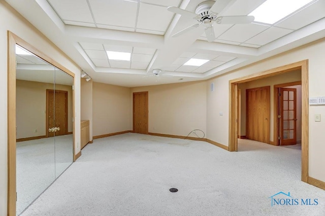 unfurnished room featuring a paneled ceiling, ceiling fan, and light colored carpet