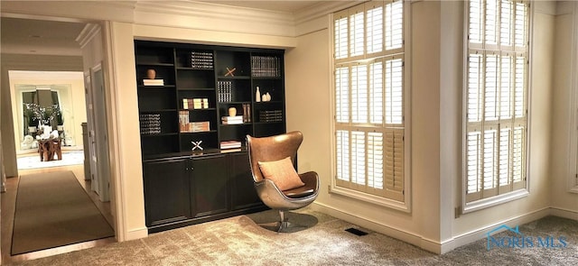 sitting room featuring carpet floors, plenty of natural light, and ornamental molding