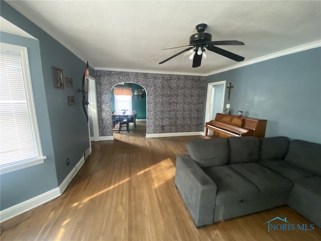 living room with ceiling fan, crown molding, and hardwood / wood-style floors