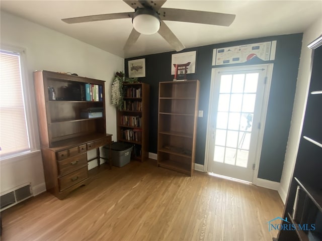 unfurnished office featuring ceiling fan and light wood-type flooring