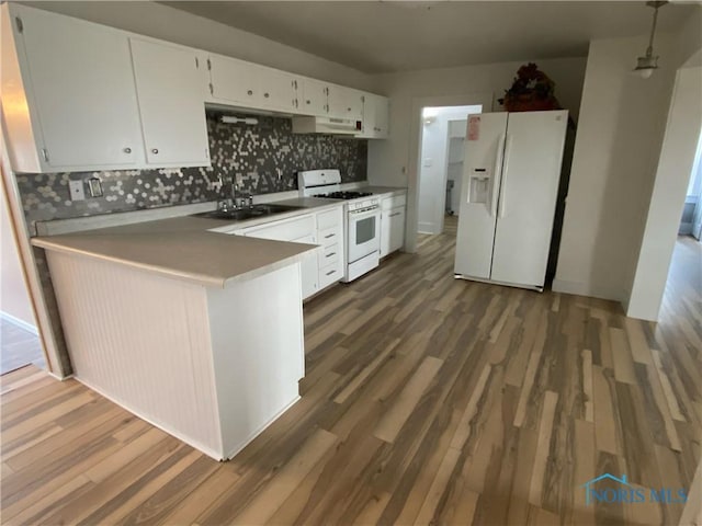 kitchen with sink, white cabinets, dark hardwood / wood-style floors, and white appliances