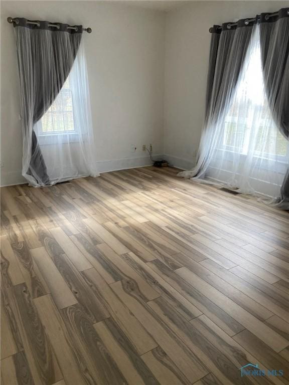 empty room with wood-type flooring