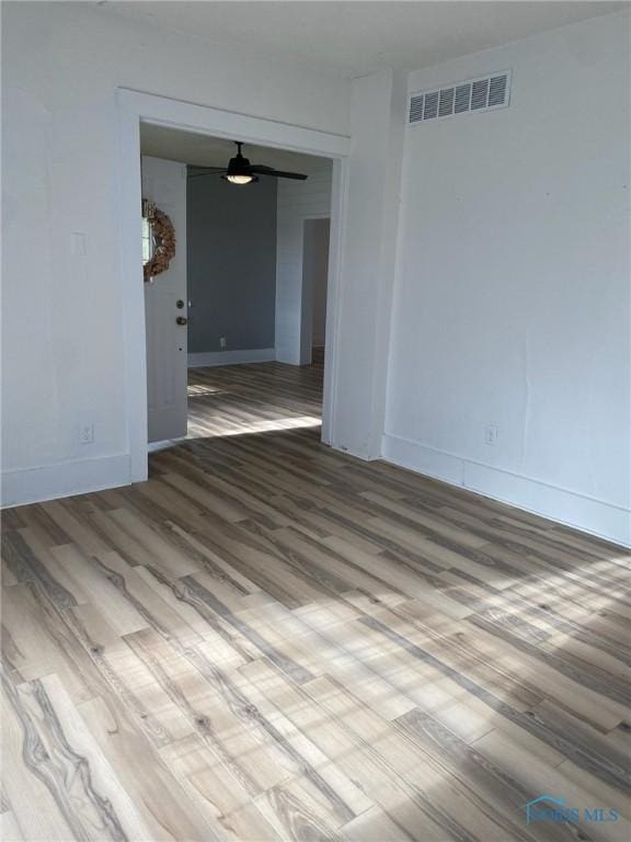 empty room featuring ceiling fan and hardwood / wood-style floors