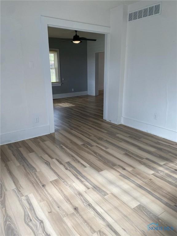 spare room with ceiling fan and hardwood / wood-style flooring