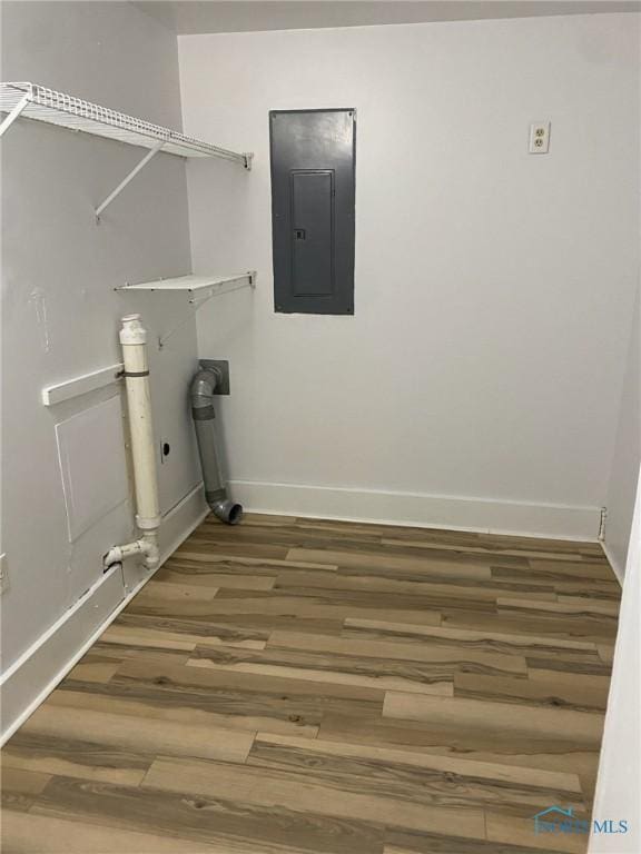 laundry area featuring wood-type flooring and electric panel