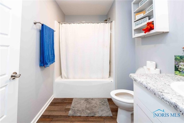 bathroom with shower / bathtub combination with curtain, toilet, wood finished floors, baseboards, and vanity