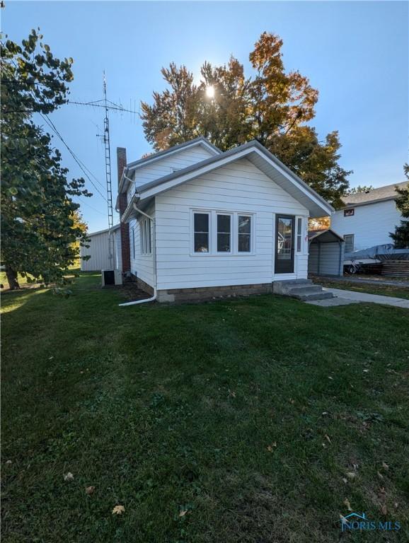 bungalow-style house featuring a front yard