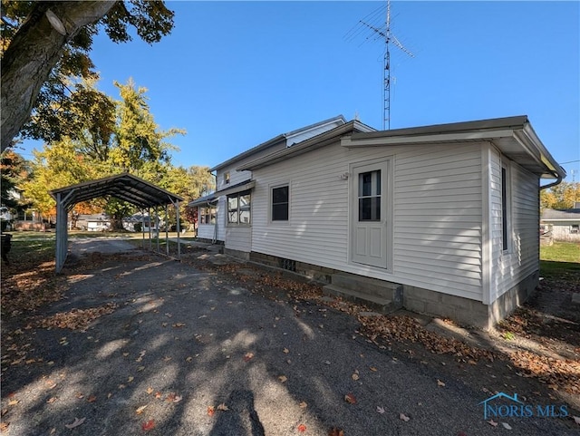 view of side of property with a carport