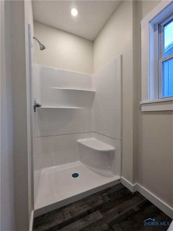 bathroom with walk in shower and hardwood / wood-style flooring