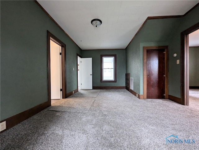 unfurnished bedroom with light carpet and crown molding