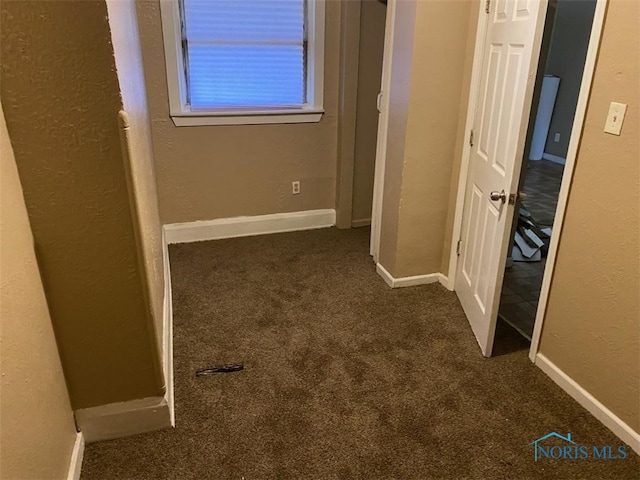 corridor with dark colored carpet