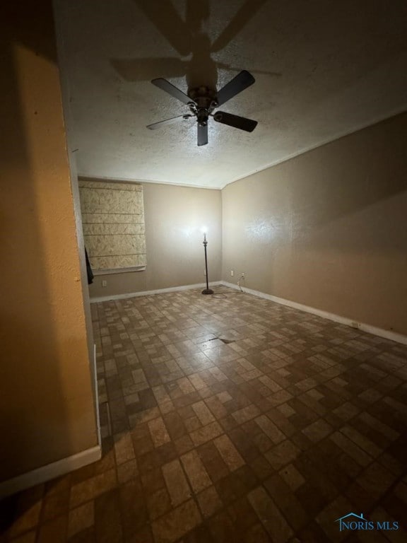 spare room featuring ceiling fan and a textured ceiling