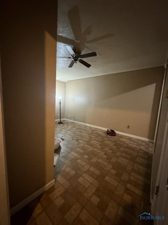 bonus room with ceiling fan and a textured ceiling