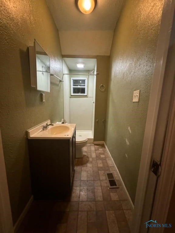 bathroom with vanity and toilet