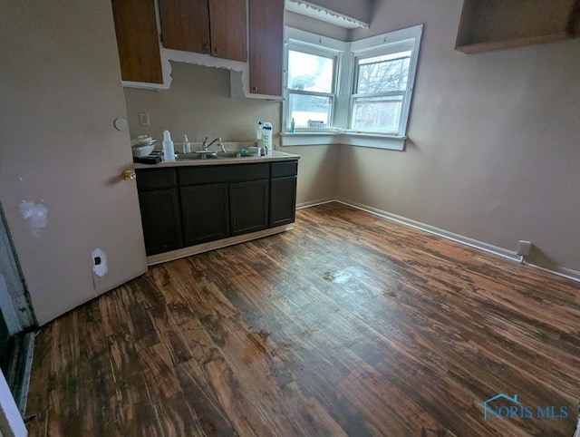 3024 N Detroit Ave, Toledo, OH 43610 - kitchen with dark wood-style floors, a sink, and light countertops