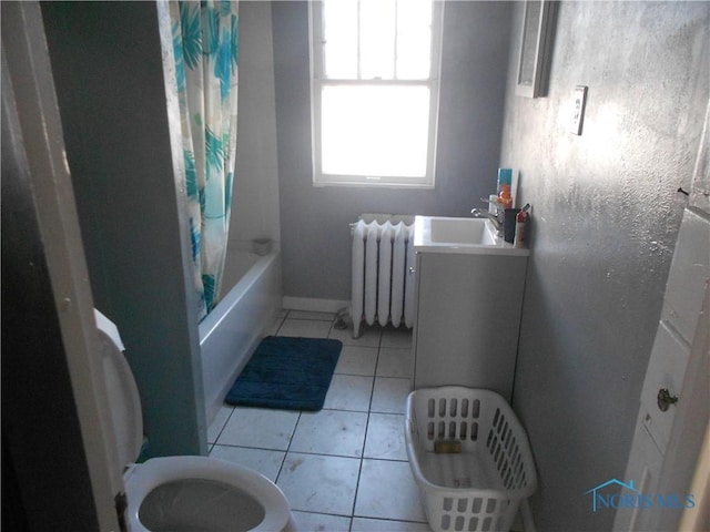 bathroom featuring tile patterned flooring, radiator, shower / bath combo with shower curtain, and sink