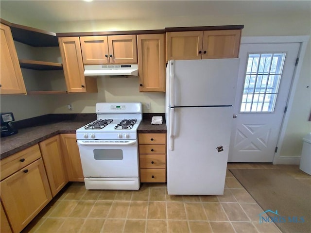 kitchen featuring light tile patterned flooring and white appliances