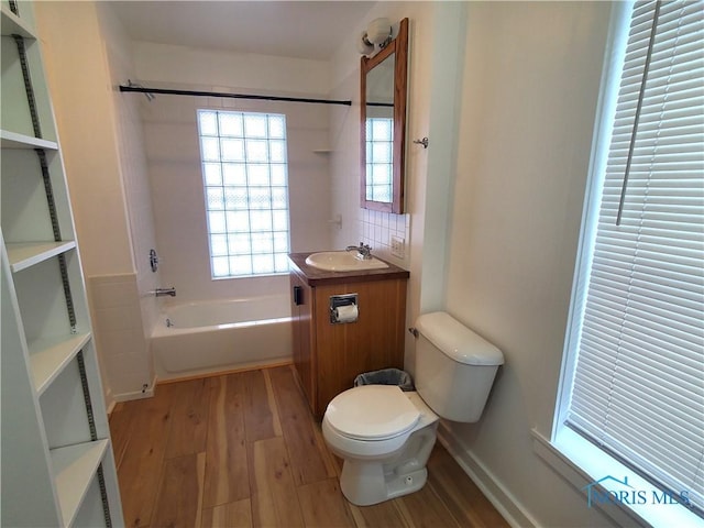 full bathroom with vanity, hardwood / wood-style flooring, toilet, and shower / washtub combination